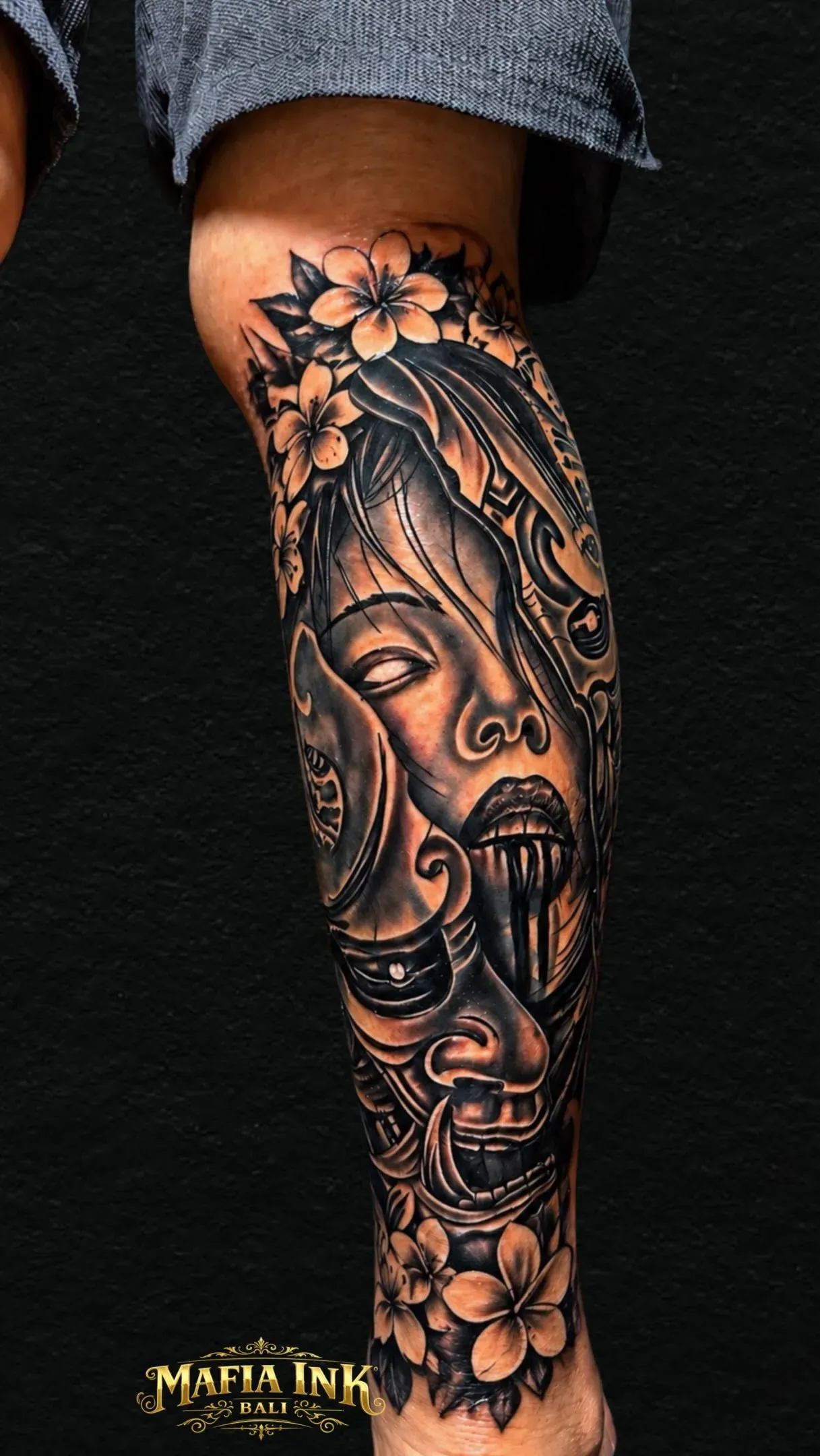Mask & floral sleeve tattoo by The Mafia Ink Bali