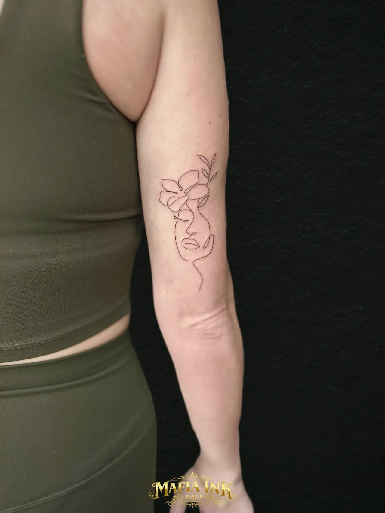 Fine-line face & flower tattoo by The Mafia Ink Bali